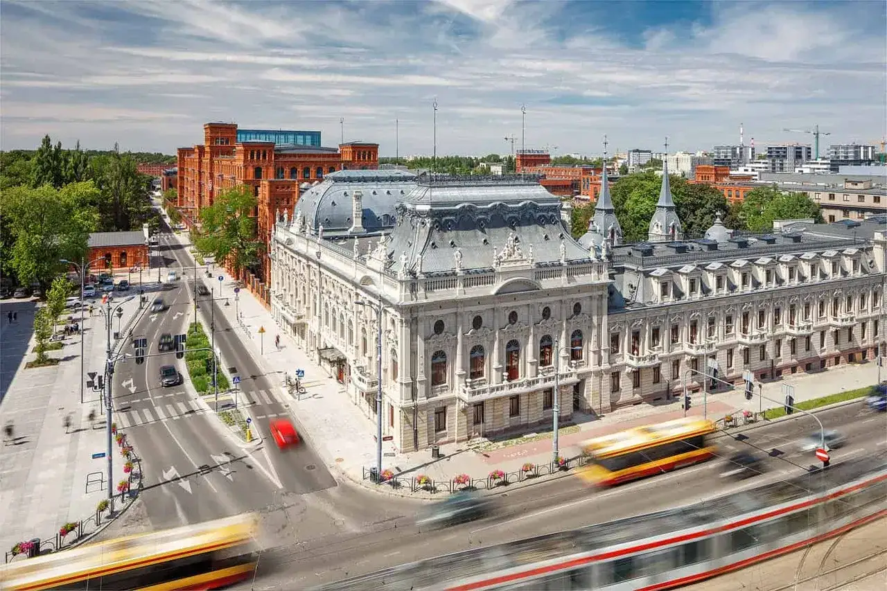 Elegancki pałac poznańskiego otoczony nowoczesną architekturą i tętniącą życiem ulicą z tramwajami w ruchu.